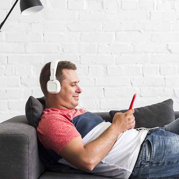 smiling-man-listening-music-with-headphone